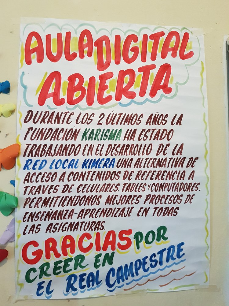 A poster with a message: “During the last 2 years, Karisma Foundation has been working in the developing of the Kimera Local Network, an alternative that provides access to resources through cell phones, tablets, and computers. Allowing us to improve our “teaching-learning” processes in all courses. Thanks for believing in the Real Campestre School”